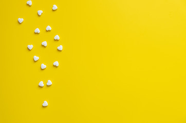 White cardiology pills on a yellow background minimalism, medicine concept