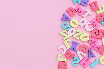 Alphabet wooden letters abstract on pink color background