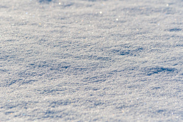 Snow cover, close-up, selective focus, shimmering with different colors.
