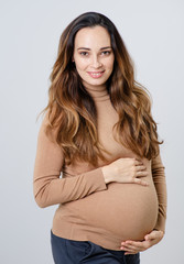 Fototapeta premium Pregnant happy Woman touching her belly.