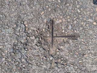 Worn down concrete block showing internal rusting metal bars.
