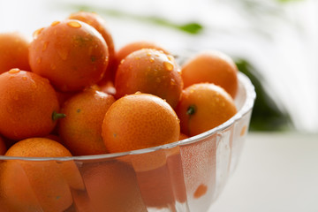Glass fruit tray with little kumquat