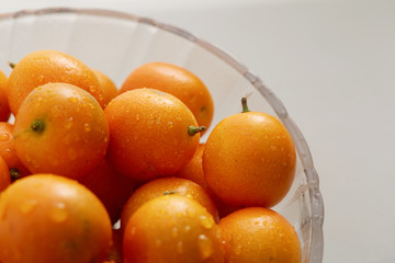 Glass fruit tray with little kumquat
