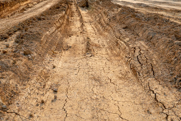 Vehicle tracks on the road for background of construction or transportation.