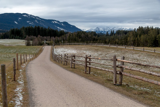 Road with a fence in the bavarian foothills 