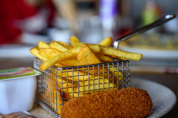 Traditional Dutch fast food snacks, fricandel and french fried potato chips