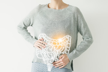 Woman in casual grey clothes suffering from indigestion pain, highlighted vector visualisation of intestine - obrazy, fototapety, plakaty