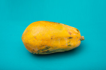 Close up photo of papaya on yellow background with copy space