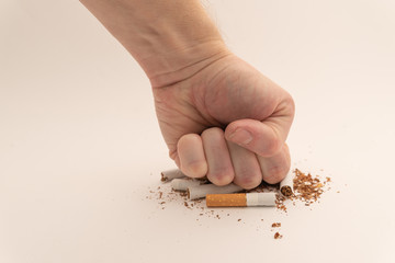 human hand crushed several cigarettes. concept of smoking cessation and healthy lifestyle