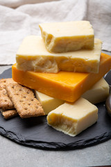 Cheese collection, matured and orange original British cheddar cheese in blocks served with crackers
