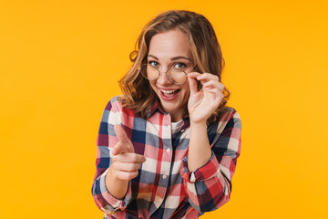 Image of young beautiful woman smiling and pointing finger at you