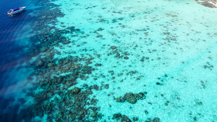 Fototapeta na wymiar Overhead aerial view of beautiful ocean with coral reef from drone
