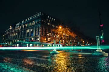 Fototapeta premium Paris, France, February 21 2020: Empty long exposure light trail shot road view from a Paris Street for design background during night