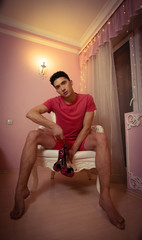 Attractive young man trying on high-heeled model shoes.