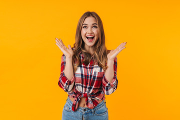 Image of happy young attractive woman screamng and raising hands