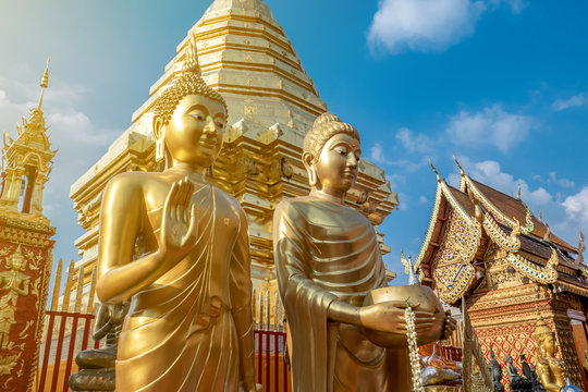 The golden Buddha images in the famous temple called Doi Suthep in the sunny day , public area. 