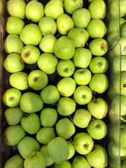 Many apples on street market counter