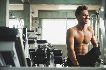 Fototapeta na wymiar A handsome young man standing posing in a gym. Healthy concept