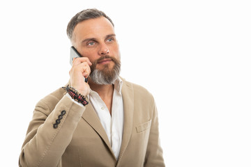 Man wearing smart casual clothes talking at smartphone