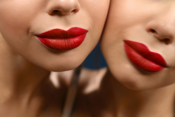 Obraz premium Beautiful woman with red lipstick near mirror, closeup