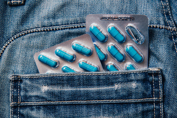 Two packages of blue capsules in the pocket of his pants.Pills for men's health and sexual energy...