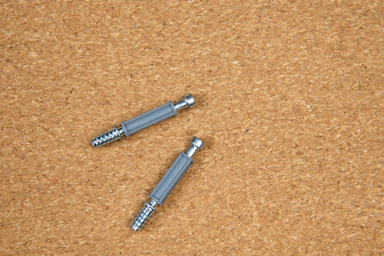 screws and screwdriver on wooden background