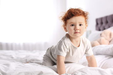 Fototapeta premium Cute little child on bed at home