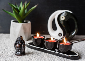 Composition with Buddhist symbols: yin yang, turtles, elephants, aroma candles, rosaries and bells....