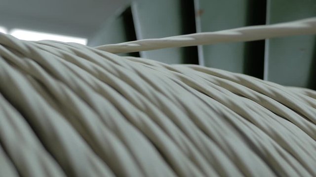Winding cable on a rotating coil. Production of electric cable.