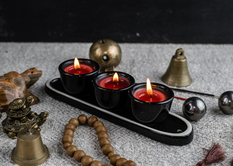 Composition with Buddhist symbols: yin yang, turtles, elephants, aroma candles, rosaries and bells. feng shui and zen concept