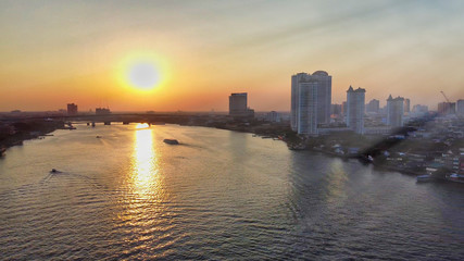 Obraz premium Bangkok, Thailand. Aerial view of cityscape and Chao Phraya River ar sunset