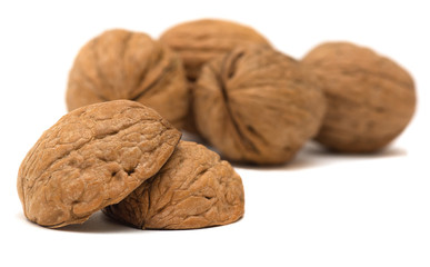 Delicious whole and broken walnuts, isolated on white background