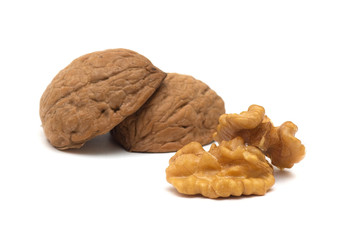 Delicious whole and broken walnuts, isolated on white background