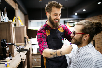 Client during beard and moustache grooming in barber shop