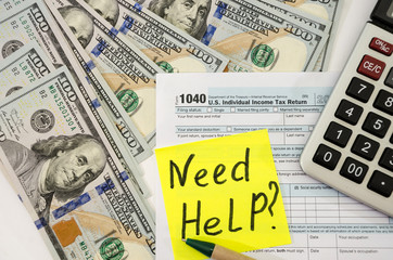 tax form 1040 with calculator, dollars and pen. The inscription 