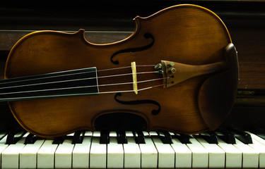 violin on piano keys top.