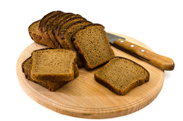 Sliced rye bread with knife on cutting board. Isolated on white.