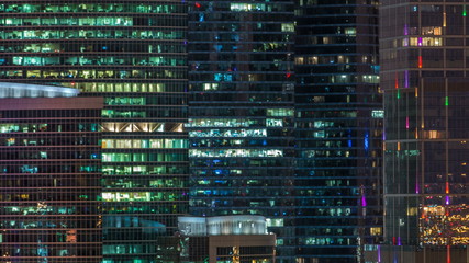 Modern office building with glowing windows at night timelapse. Moscow city