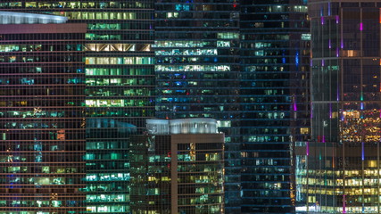 Modern office building with glowing windows at night timelapse. Moscow city
