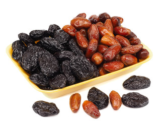 Mixed dried fruit: prunes and dates on a white background