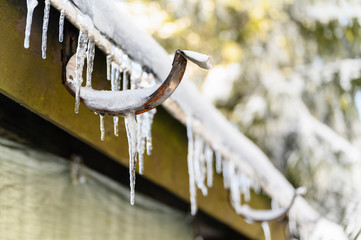 Gutter holders and ice stalactites on the roof.