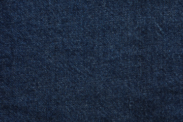 Texture of dark blue jeans as background, closeup