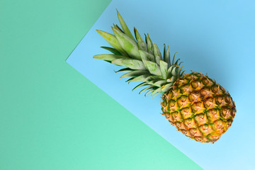 Pineapple on a blue and green background. Copy space.