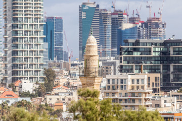 The old Mahmoudiya Mosque buildlig on the background of the high-rise buildings of Tel Aviv in old...