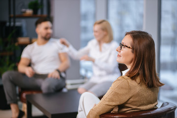 healthcare concept: married couple visit psychologist doctor. man and woman try to explain problems of relationships, psychologist sit listening them and giving advice. people, relationships, family