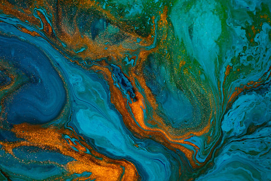 Fluid art texture. Abstract background with iridescent paint effect. Liquid acrylic artwork with colorful mixed paints. Can be used for background or poster. Blue, green and golden overflowing colors