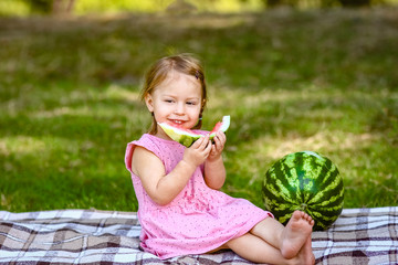 happy child with watermelon on nature in the park