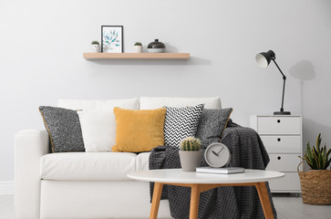 Elegant white sofa in modern living room interior