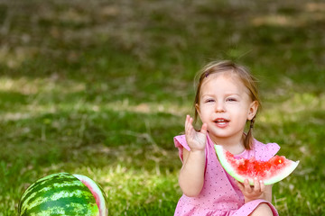 happy child with watermelon on nature in the park