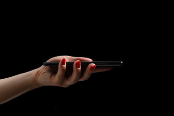 woman hands using modern mobile phone on black background - Powered by Adobe